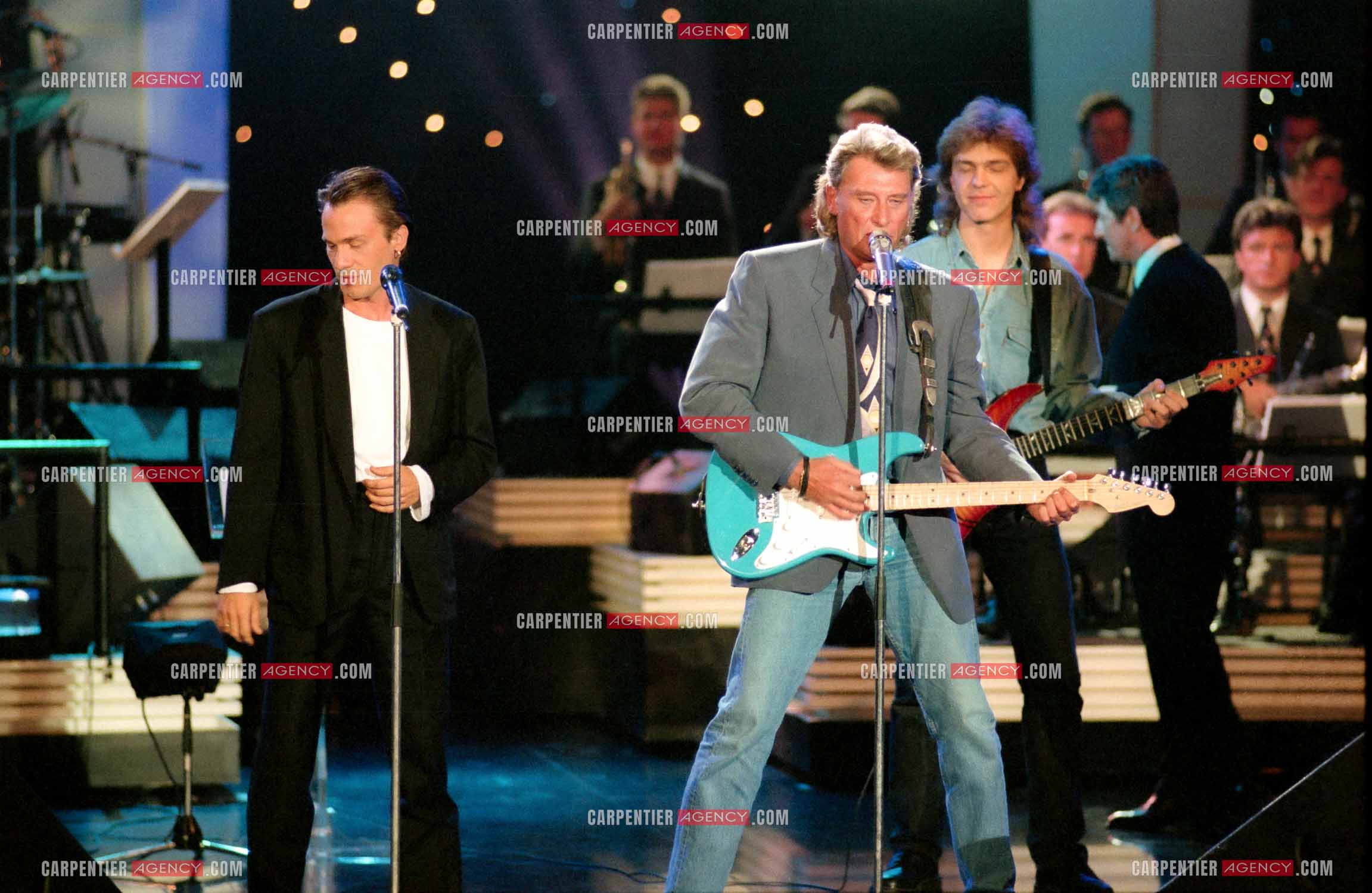 Le chanteur Johnny Hallyday accompagné de son guitariste Thibault Abrial en duo avec Florent Pagny pour l'enregistrement de l'émission “ Sacrée Soirée “ sur TF1 en 1992.    ( Exclusif ).